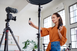 emale influencer showing product while recording video, promoting advertising using social media platforms