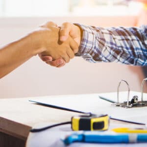 Contractor and client shaking hands
