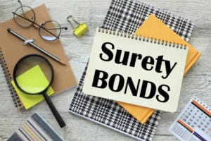 SURETY BOND. Business concept magnifying glass on notepad.text on page